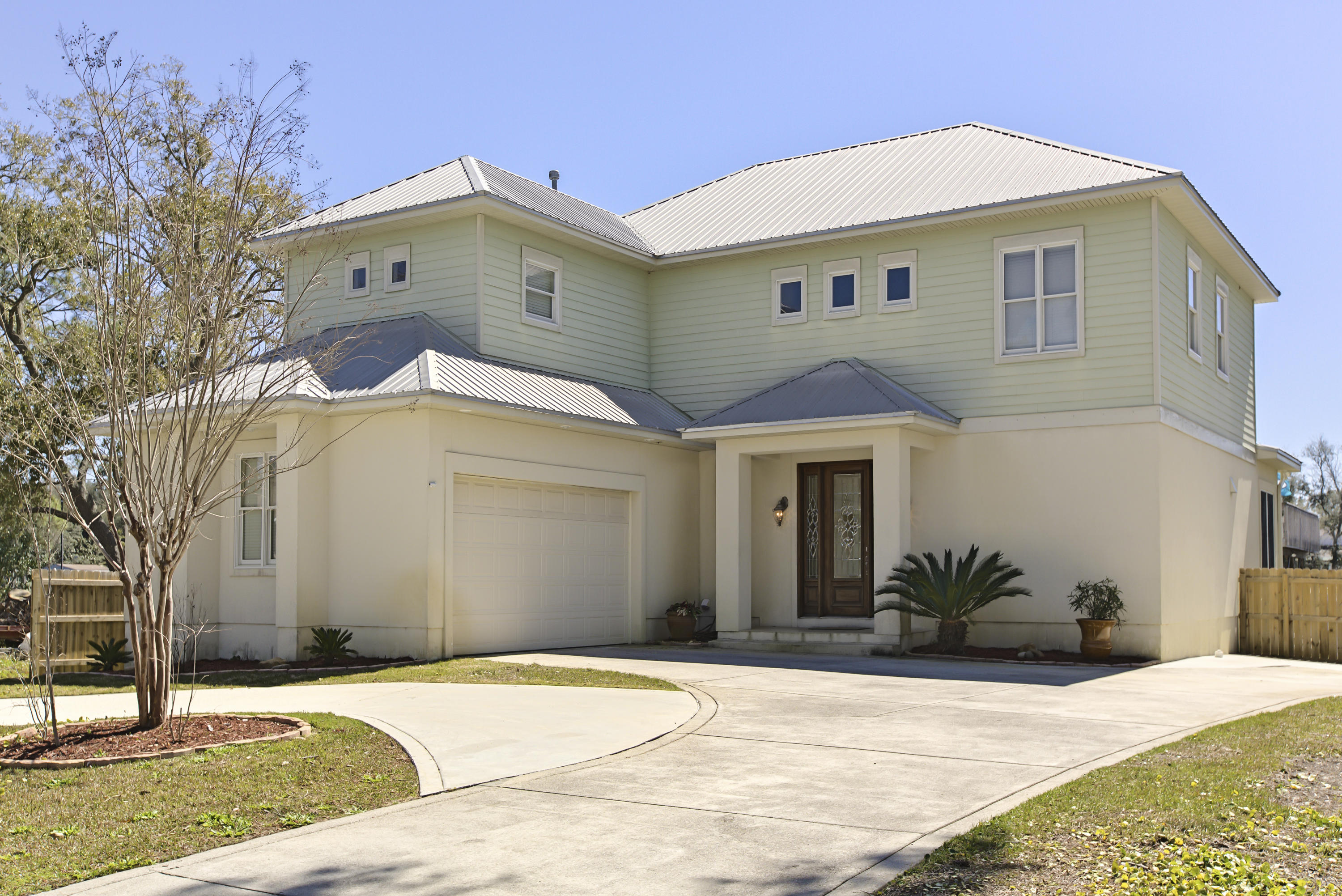 218 Buck Road Santa Rosa Beach, FL 32459 - Photo 2 of 25 a front view of a house with a yard