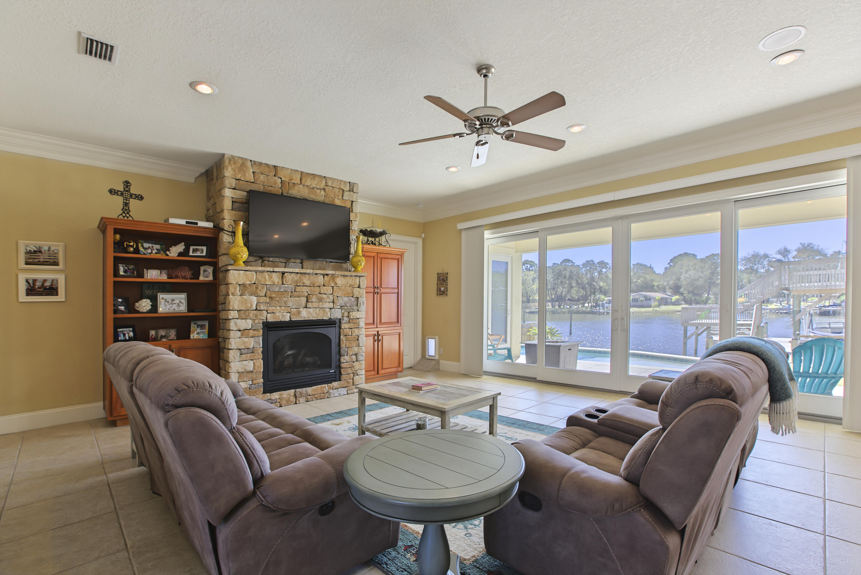 218 Buck Road Santa Rosa Beach, FL 32459 - Photo 3 of 25 a living room with furniture a fireplace and a flat screen tv