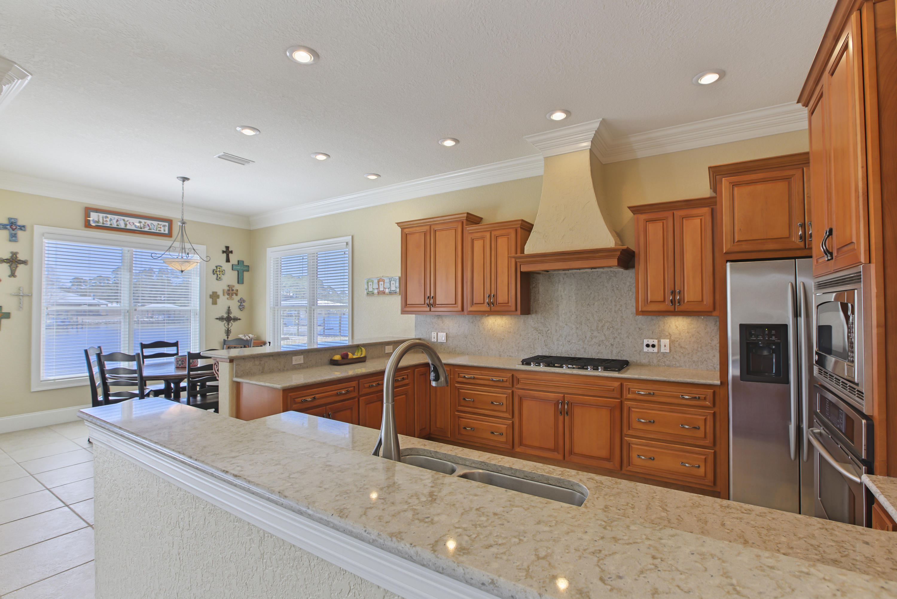 218 Buck Road Santa Rosa Beach, FL 32459 - Photo 7 of 25 a kitchen with stainless steel appliances granite countertop a sink and cabinets