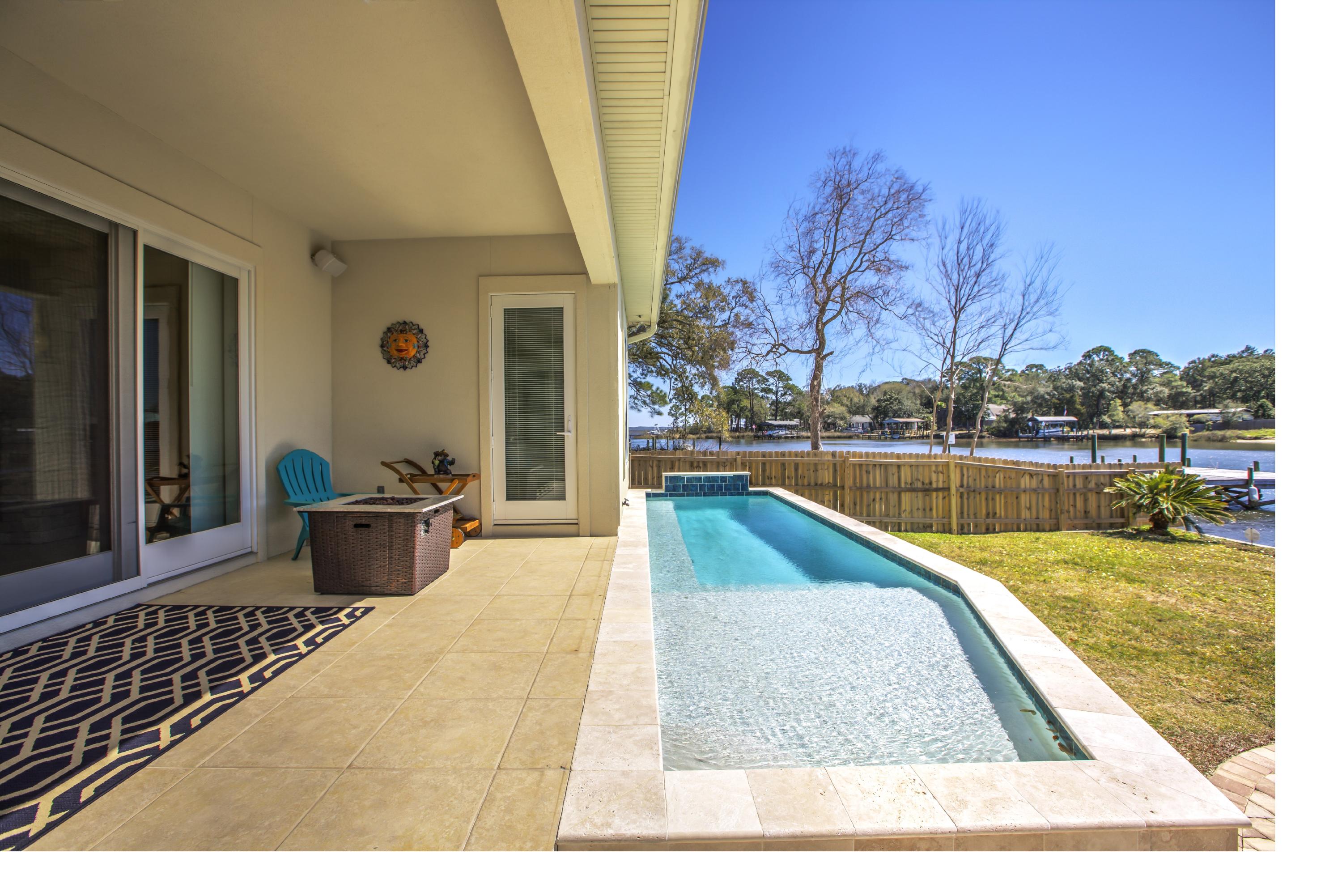 218 Buck Road Santa Rosa Beach, FL 32459 - Photo 10 of 25 a view of a swimming pool with lounge chair