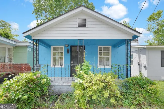 a front view of a house with garden