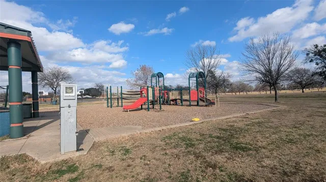 a view of a park with swings and slides