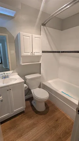 a bathroom with a toilet a sink and bathtub