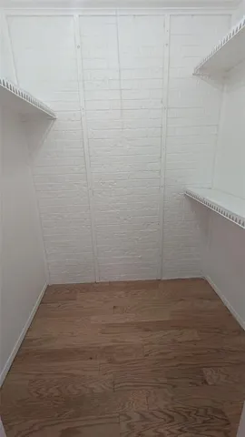 a view of a small space with wooden floor