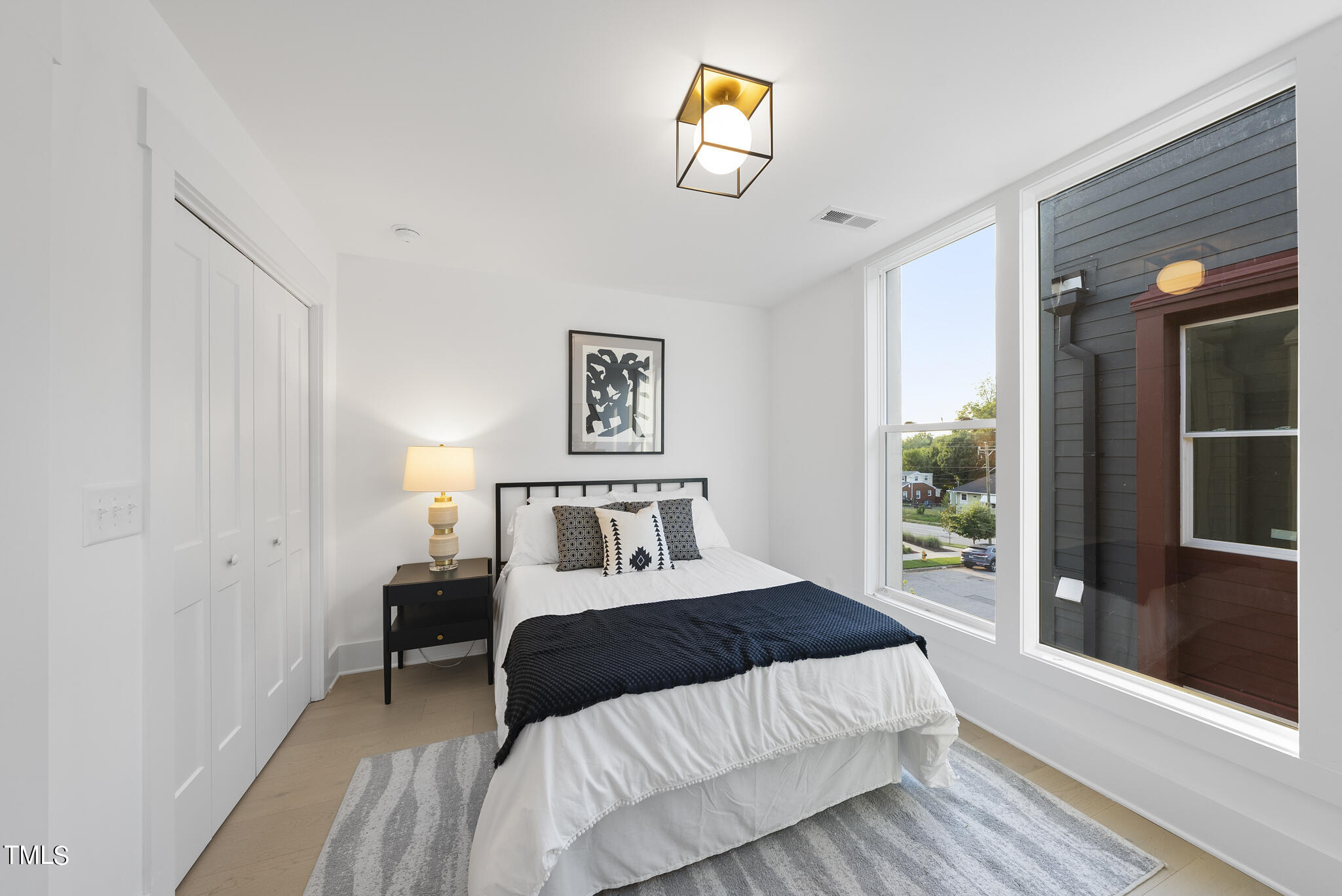 2 Seawell Avenue, Unit 105 Raleigh, NC 27601 - Photo 13 of 40 a bedroom with a bed and a painting on the wall