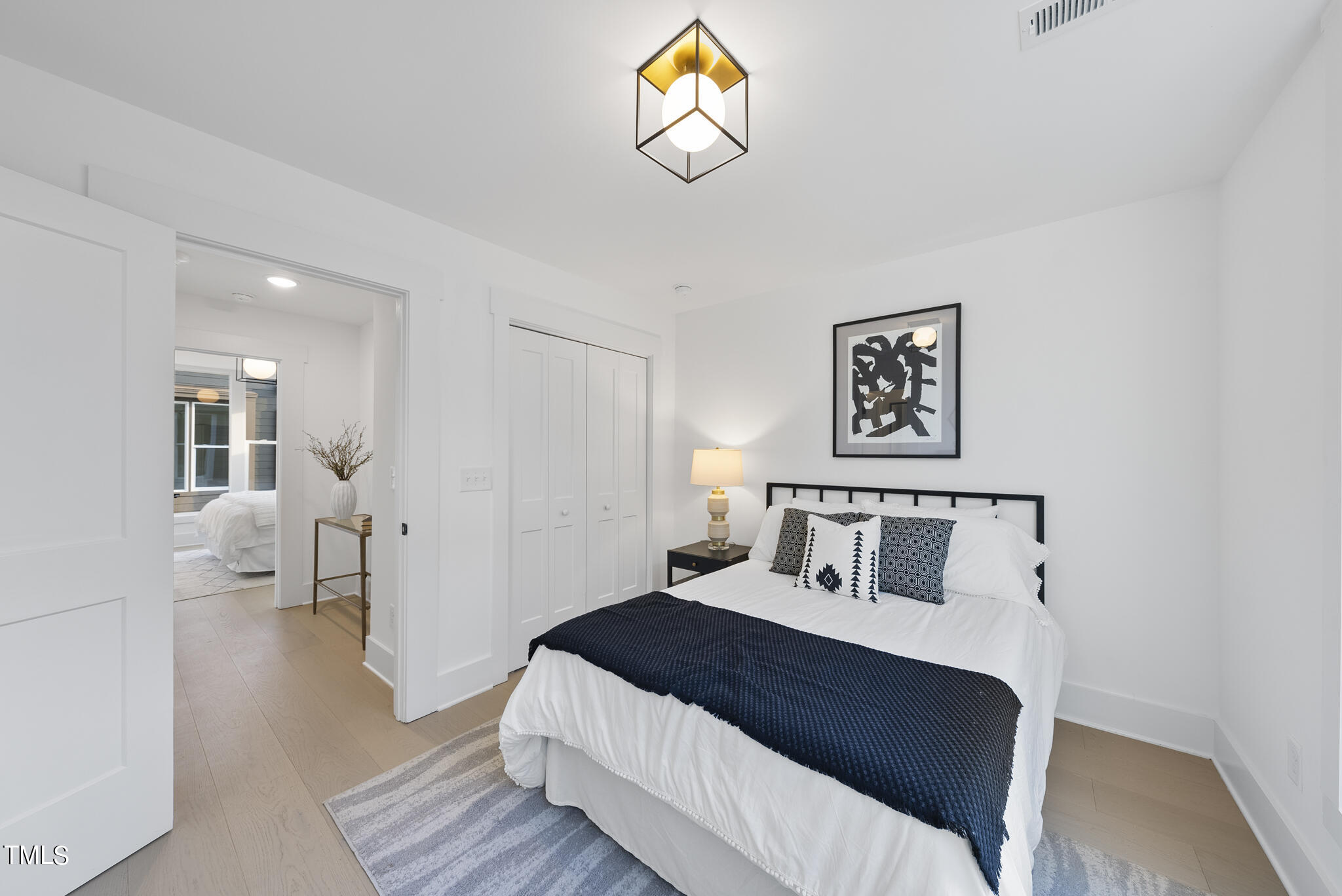 2 Seawell Avenue, Unit 105 Raleigh, NC 27601 - Photo 14 of 40 a bedroom with a bed and a chandelier