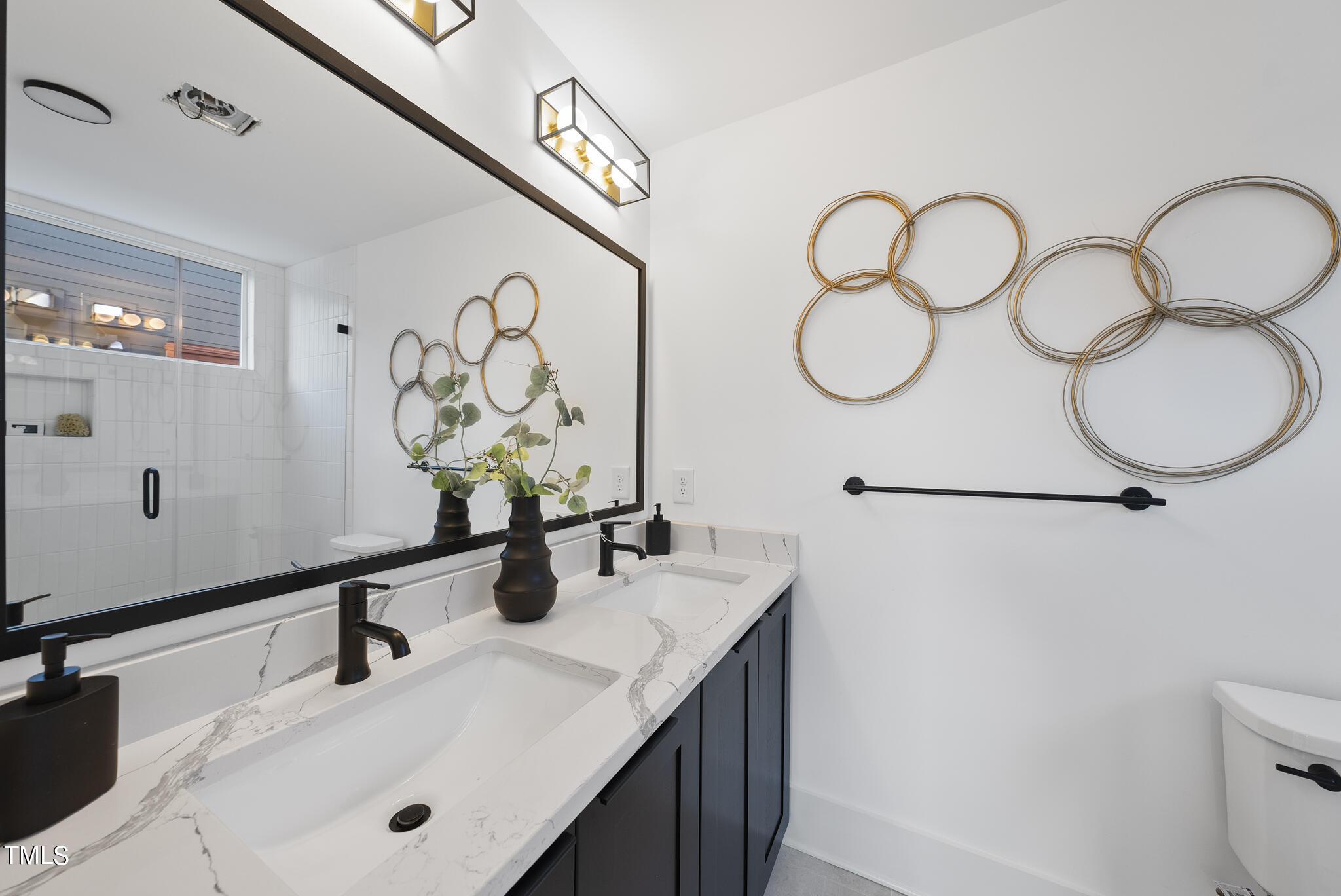 2 Seawell Avenue, Unit 105 Raleigh, NC 27601 - Photo 18 of 40 a bathroom with a sink and a mirror