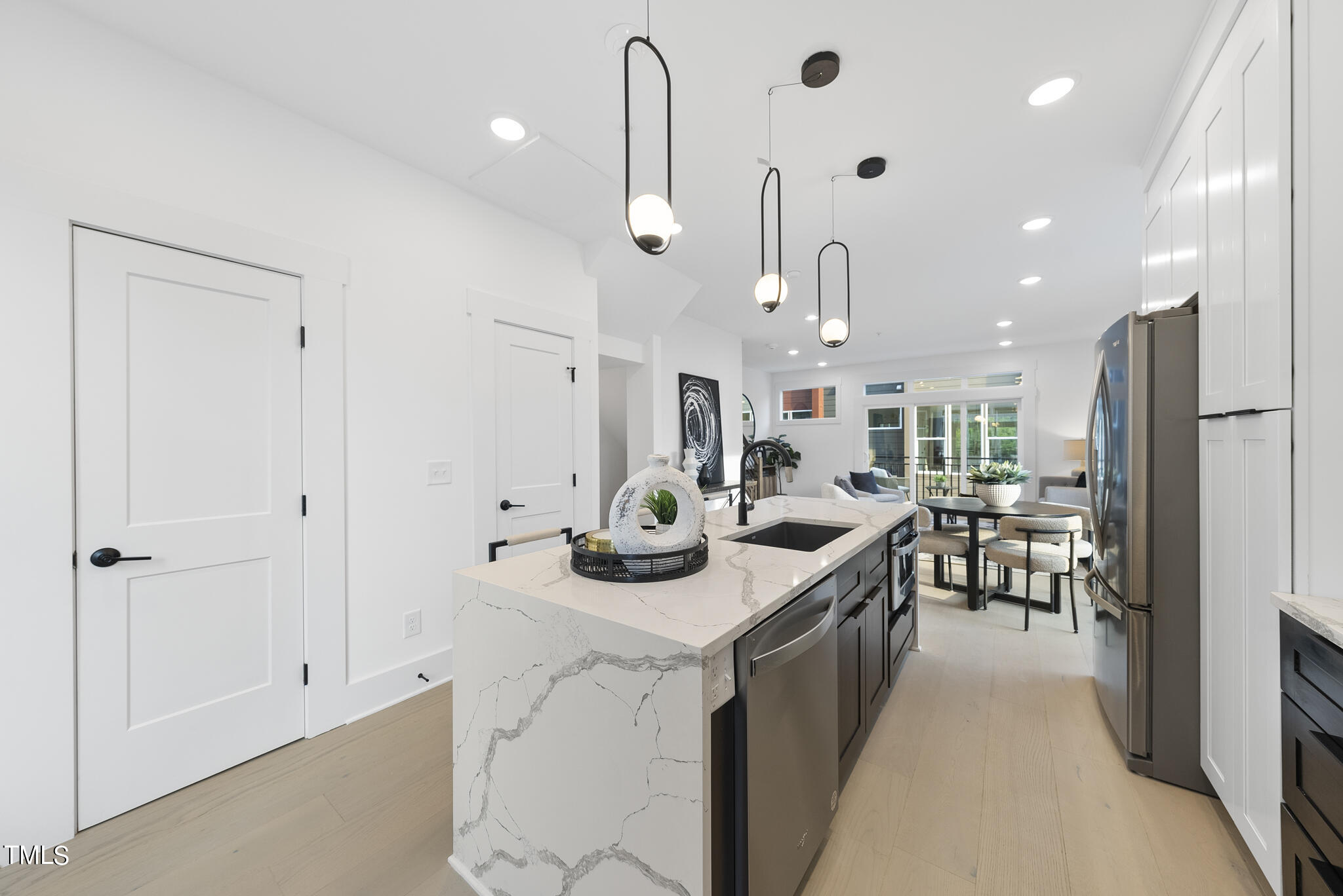 2 Seawell Avenue, Unit 105 Raleigh, NC 27601 - Photo 5 of 40 a kitchen with stainless steel appliances kitchen island granite countertop a lot of counter space and a sink