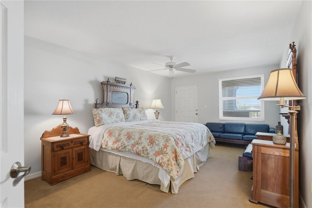 16326 Gulf Boulevard, Unit 307 Redington Beach, FL 33708 - Photo 22 of 43 a bedroom with a bed and a chandelier
