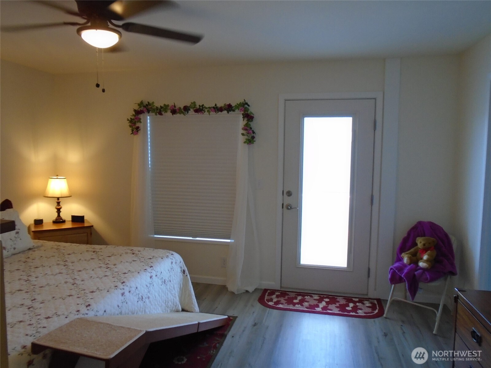894 North Iris Avenue Sequim, WA 98382 - Photo 20 of 38 a bedroom with a bed and a chandelier