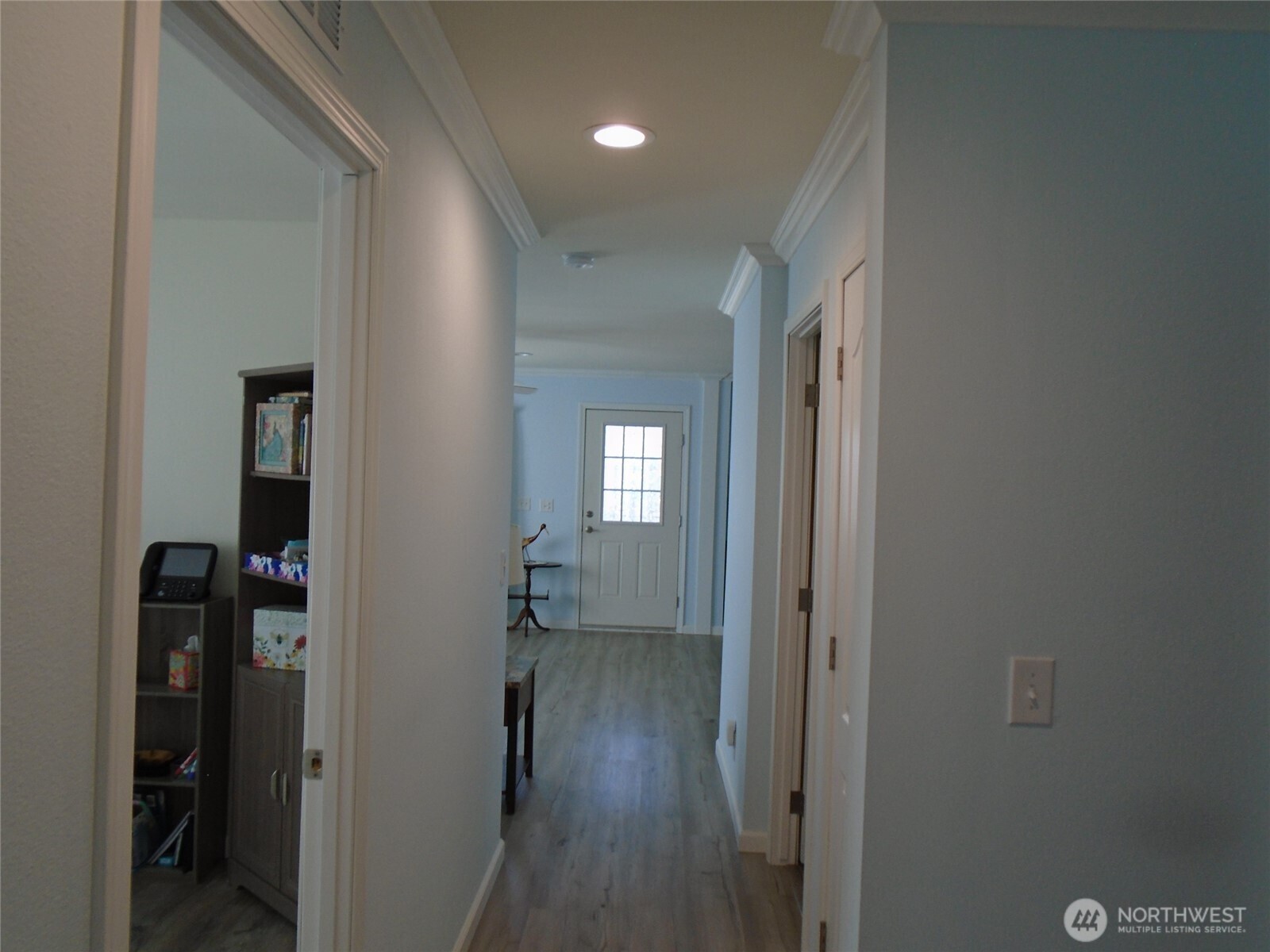894 North Iris Avenue Sequim, WA 98382 - Photo 25 of 38 a view of a hallway with wooden floor and a room