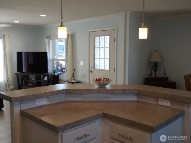 a kitchen with a sink a counter top space and a window