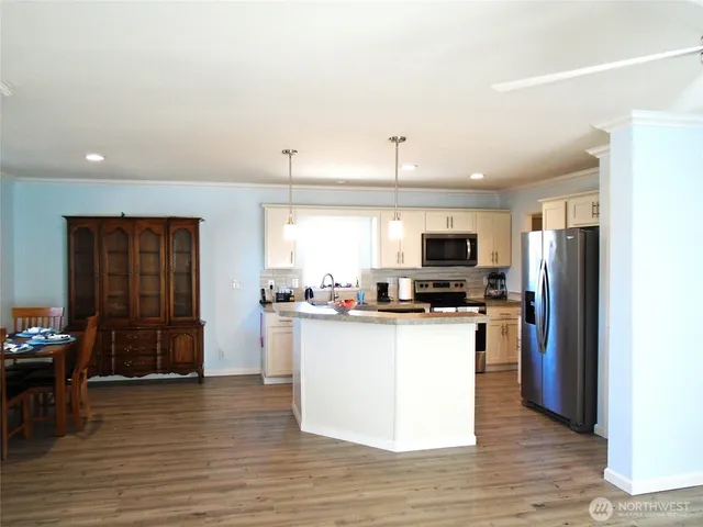 a kitchen with stainless steel appliances a refrigerator and a stove top oven