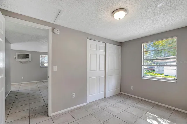 an empty room with windows and closet