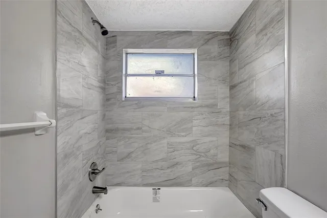 a bathroom with a bathtub and window