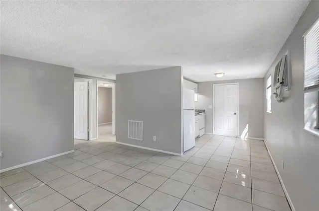 a view of an empty room and a window