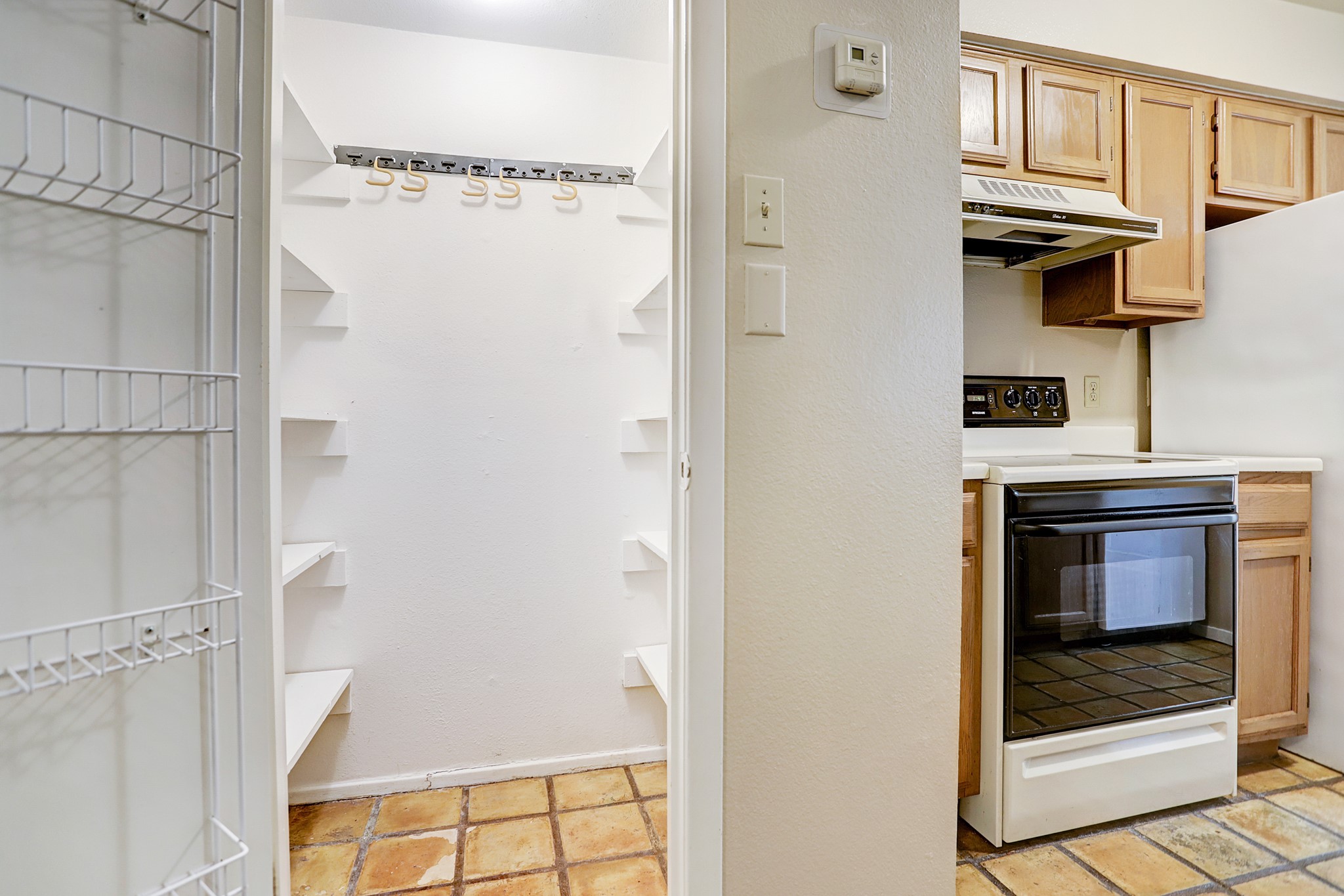305 Avondale Street, Unit B Houston, TX 77006 - Photo 4 of 12 a kitchen with a refrigerator and white cabinets