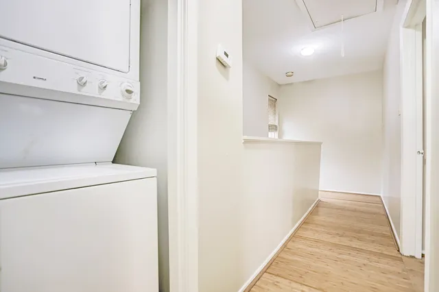 a view of washer and dryer with kitchen in the background