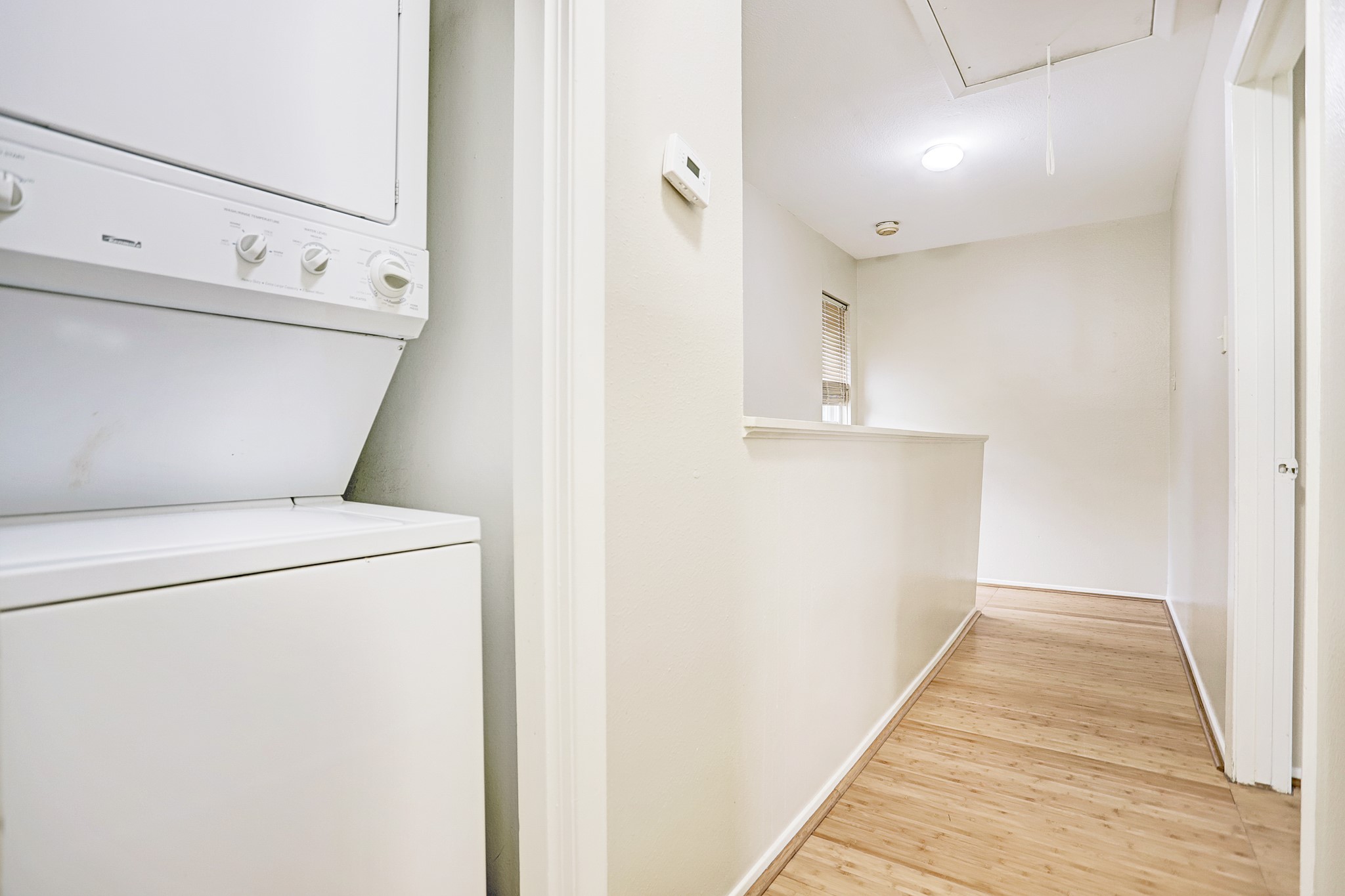 305 Avondale Street, Unit B Houston, TX 77006 - Photo 7 of 12 a view of washer and dryer with kitchen in the background