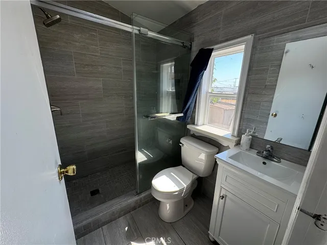 a bathroom with a toilet sink and shower
