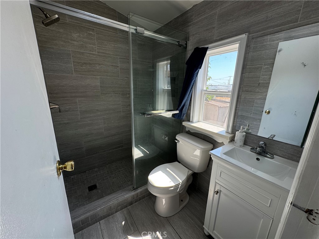 a bathroom with a toilet sink and shower