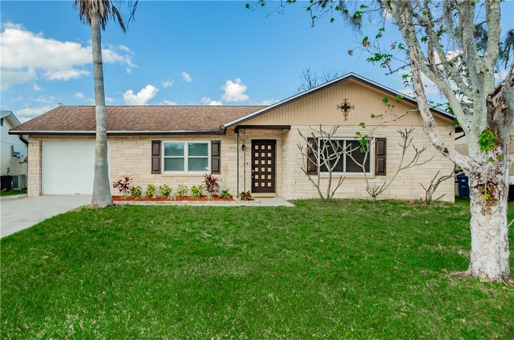 7053 Daggett Terrace New Port Richey, FL 34655 - Photo 1 of 1 a front view of a house with a yard