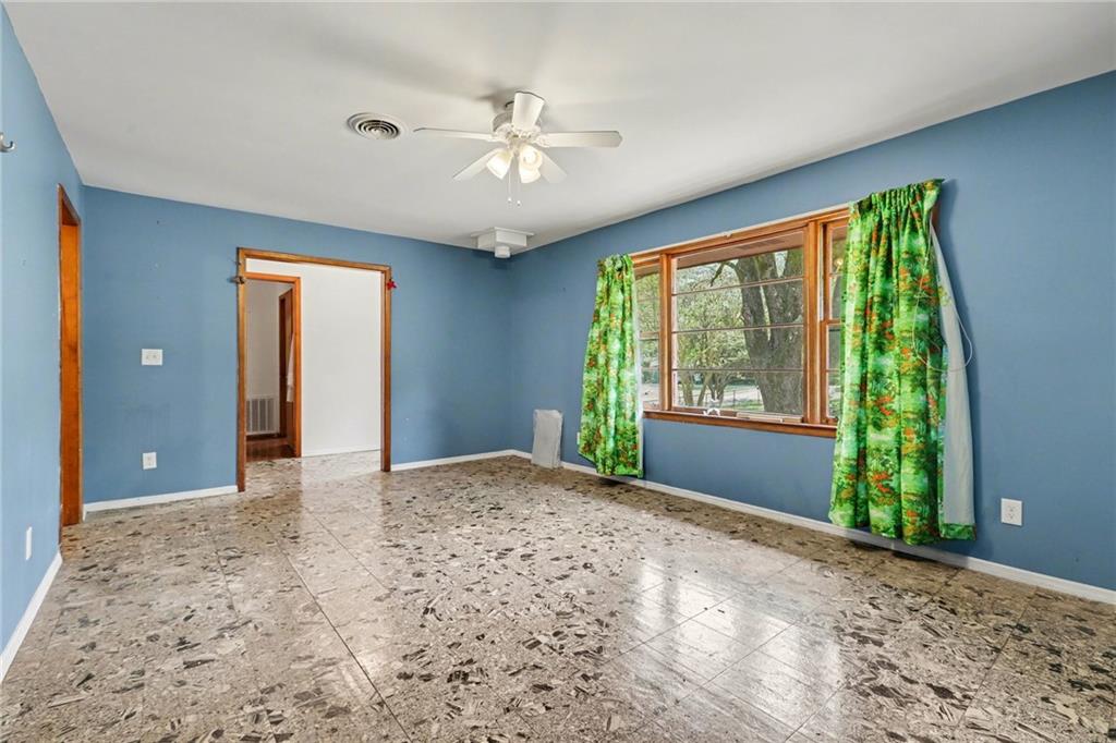 7019 Lake View Lane Doraville, GA 30360 - Photo 8 of 32 a view of a big room with windows and chandelier fan