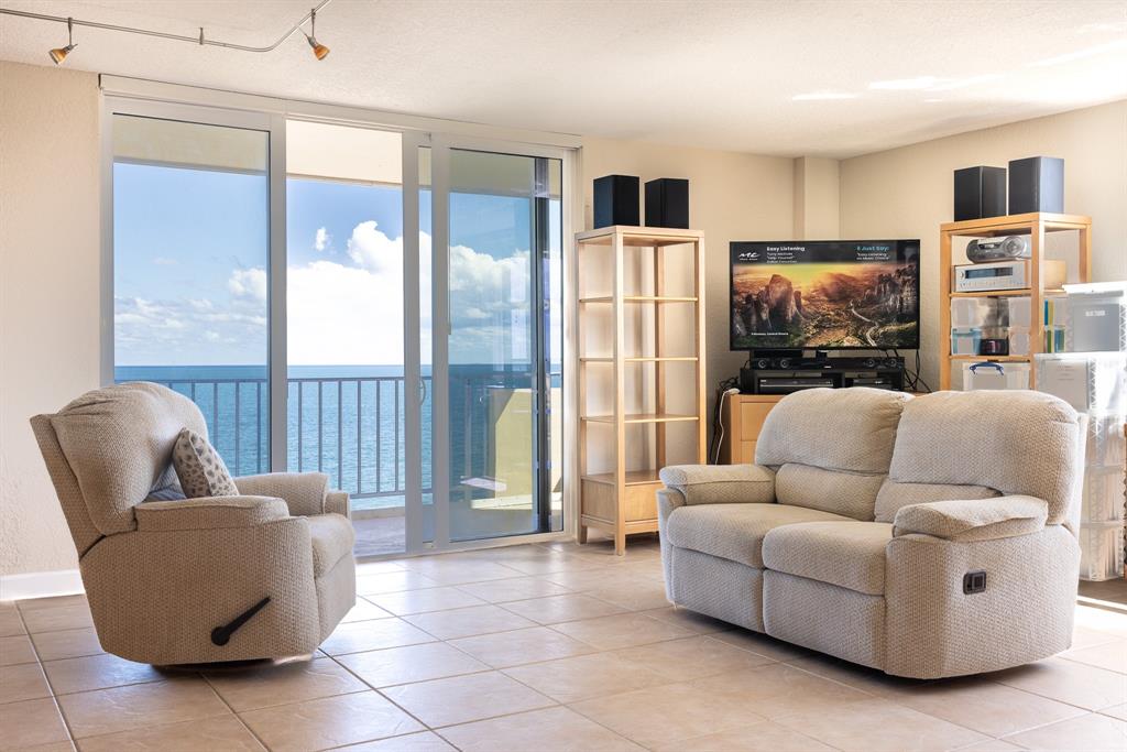 2000 South Ocean Boulevard, Unit 10E Lauderdale-by-the-Sea, FL 33062 - Photo 11 of 86 a living room with furniture and a flat screen tv