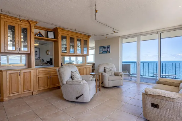 a large kitchen with cabinets a sink and stainless steel appliances