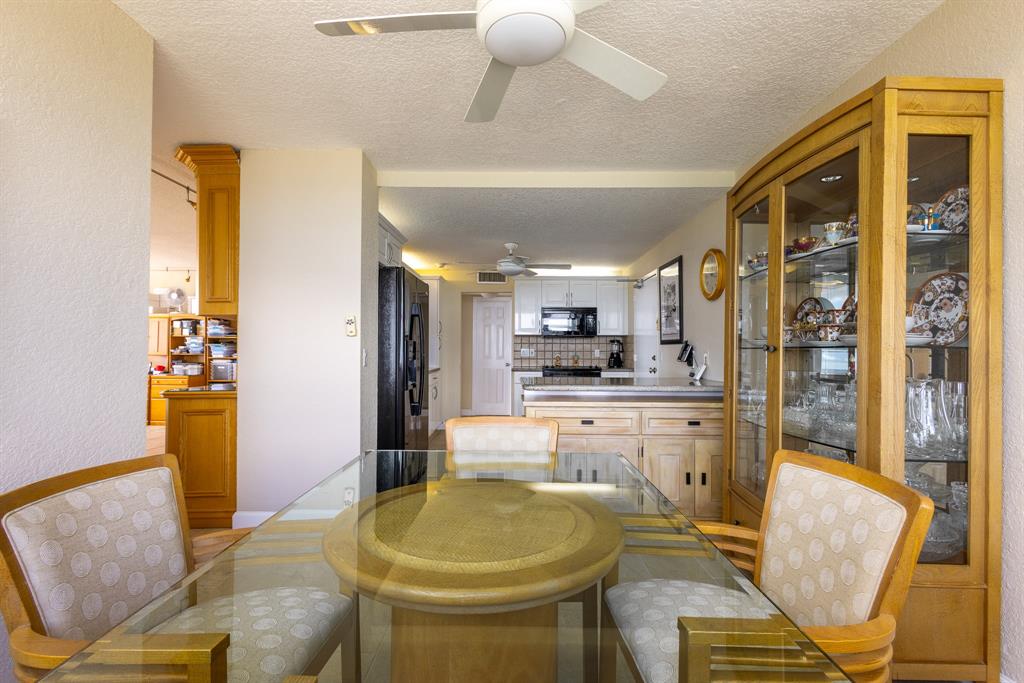 2000 South Ocean Boulevard, Unit 10E Lauderdale-by-the-Sea, FL 33062 - Photo 25 of 86 a kitchen with stainless steel appliances granite countertop a sink and a refrigerator