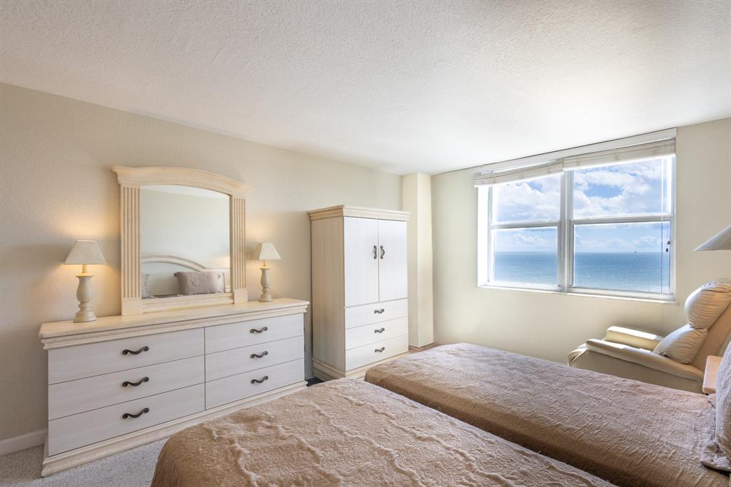 2000 South Ocean Boulevard, Unit 10E Lauderdale-by-the-Sea, FL 33062 - Photo 30 of 86 a bedroom with a large bed and a window