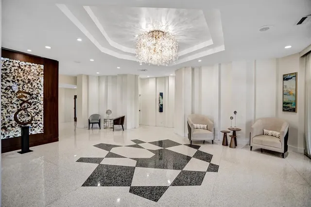 a view of a hallway with a potted plant on the counter and a mirror