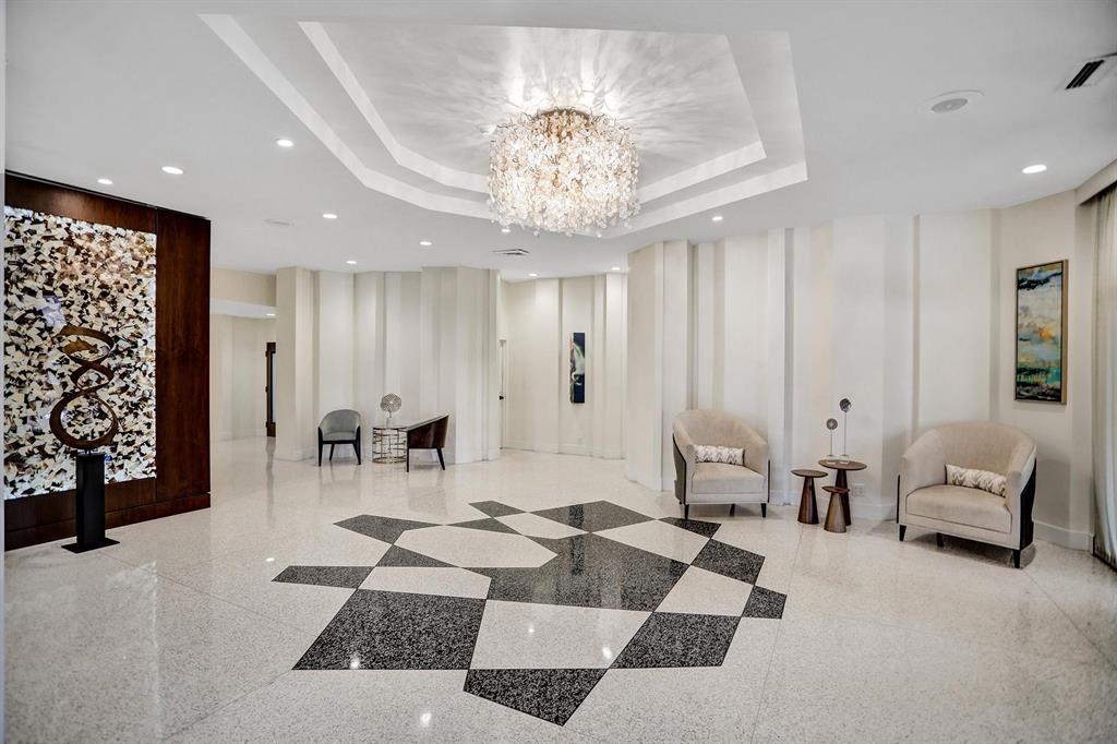 2000 South Ocean Boulevard, Unit 10E Lauderdale-by-the-Sea, FL 33062 - Photo 3 of 86 a living room with furniture and a chandelier