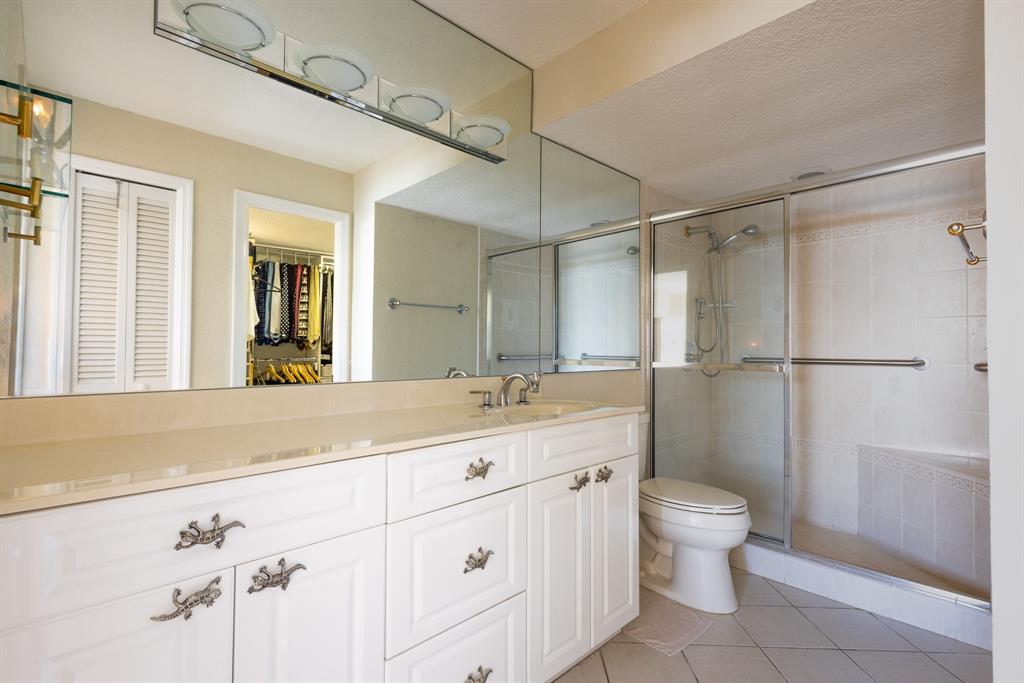 2000 South Ocean Boulevard, Unit 10E Lauderdale-by-the-Sea, FL 33062 - Photo 32 of 86 a bathroom with a granite countertop sink toilet and shower