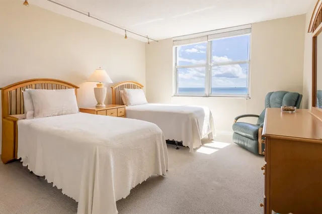 a view of a hallway with wooden floor and furniture