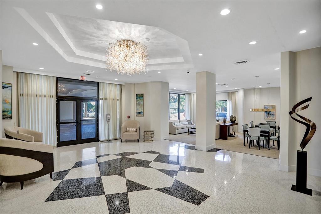 2000 South Ocean Boulevard, Unit 10E Lauderdale-by-the-Sea, FL 33062 - Photo 4 of 86 a living room with furniture a dining table and a chandelier