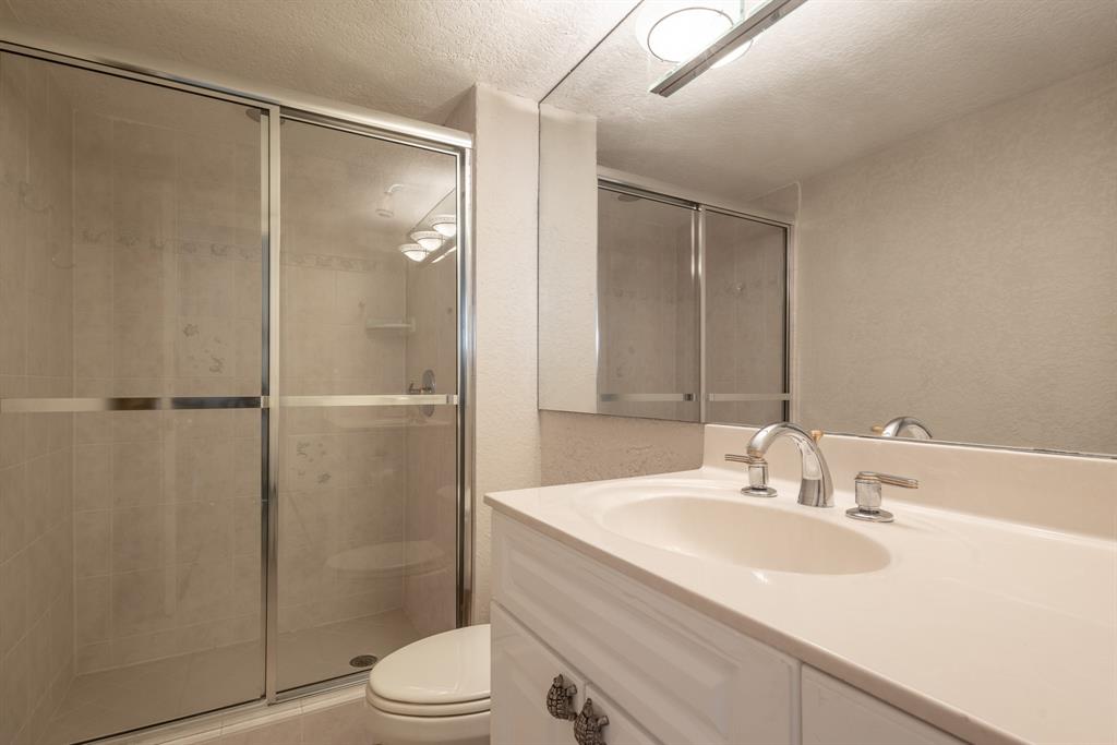 2000 South Ocean Boulevard, Unit 10E Lauderdale-by-the-Sea, FL 33062 - Photo 42 of 86 a bathroom with a sink toilet and shower