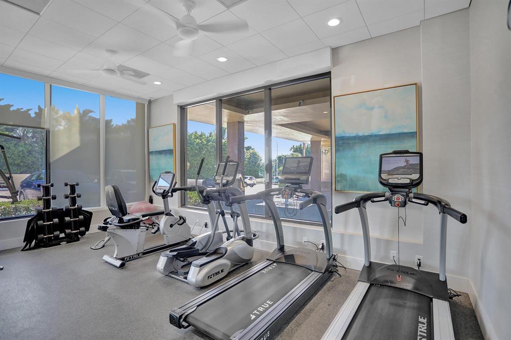 2000 South Ocean Boulevard, Unit 10E Lauderdale-by-the-Sea, FL 33062 - Photo 45 of 86 a room with gym equipment and large mirror