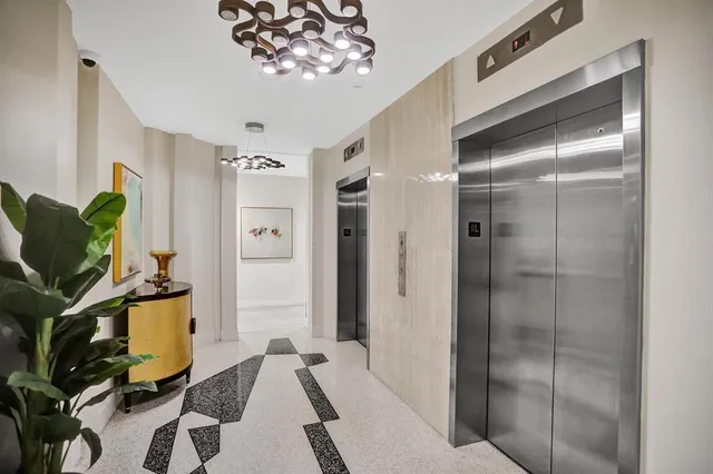 a view of hallway with a large mirror and a shower