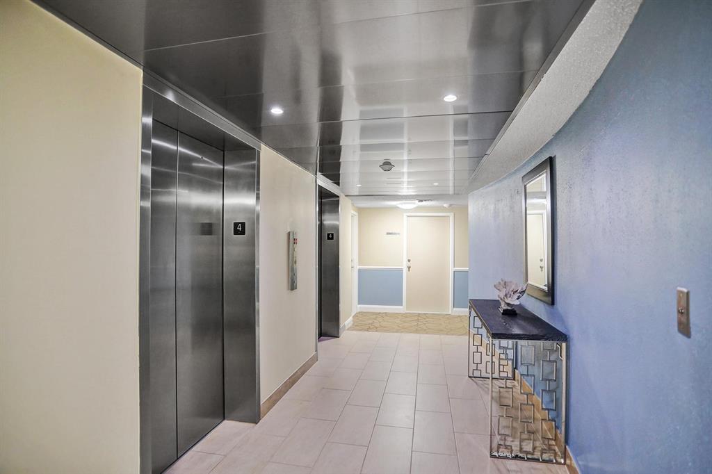 2000 South Ocean Boulevard, Unit 10E Lauderdale-by-the-Sea, FL 33062 - Photo 7 of 86 a view of hallway with a large mirror and a shower