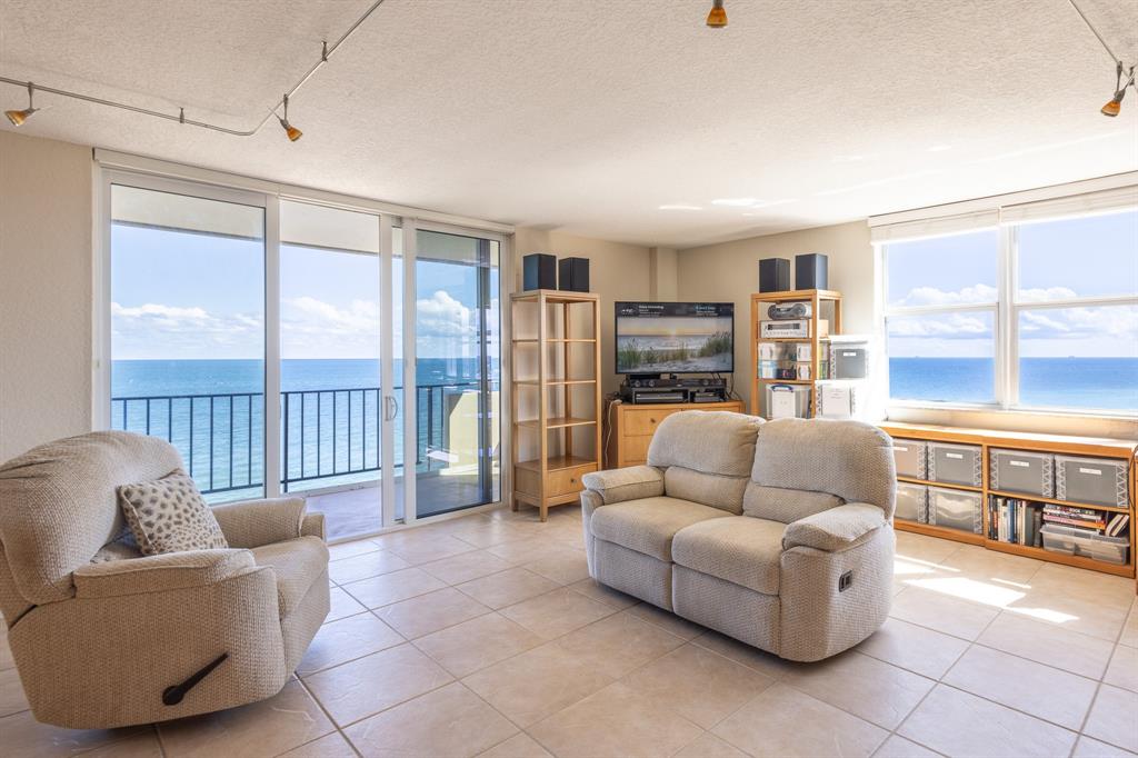 2000 South Ocean Boulevard, Unit 10E Lauderdale-by-the-Sea, FL 33062 - Photo 9 of 86 a living room with furniture and a floor to ceiling window