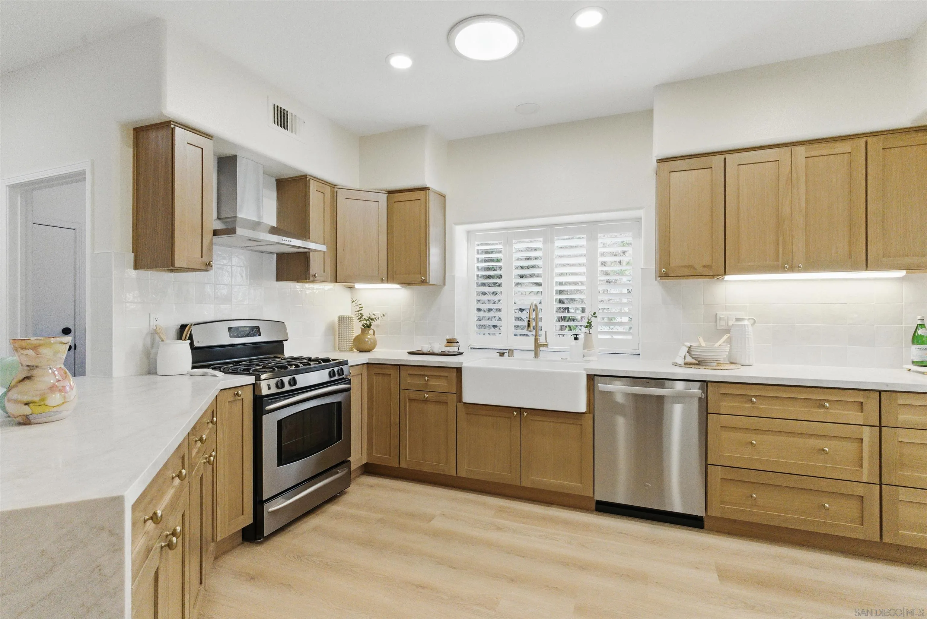 4140 Andros Way Oceanside, CA 92056 - Photo 13 of 41 a kitchen with stainless steel appliances granite countertop a stove a sink dishwasher and a refrigerator