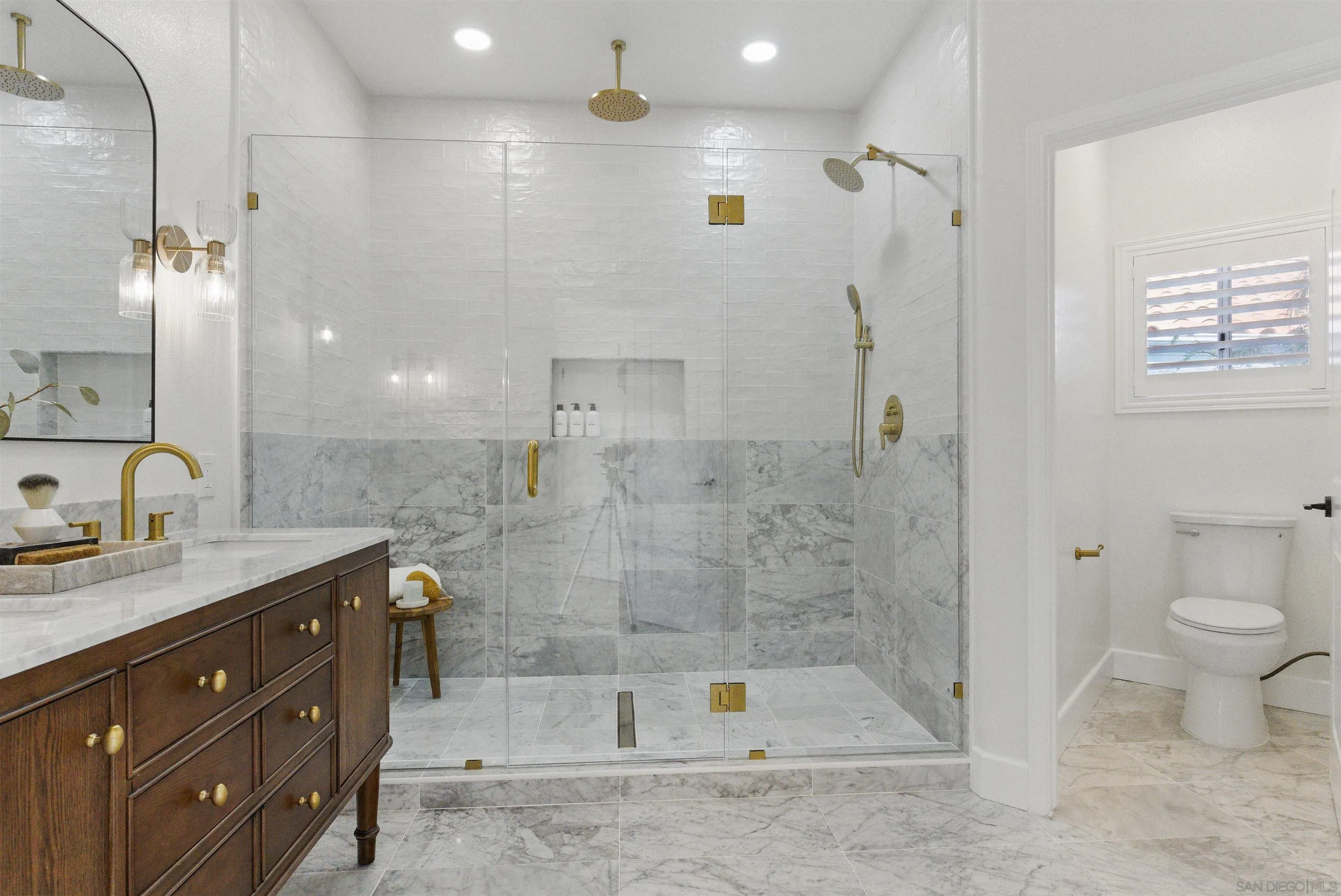 4140 Andros Way Oceanside, CA 92056 - Photo 19 of 41 a bathroom with a granite countertop sink a toilet a mirror and shower