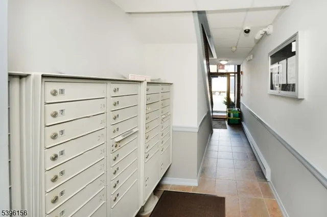 a view of hallway with stairs and wooden floor