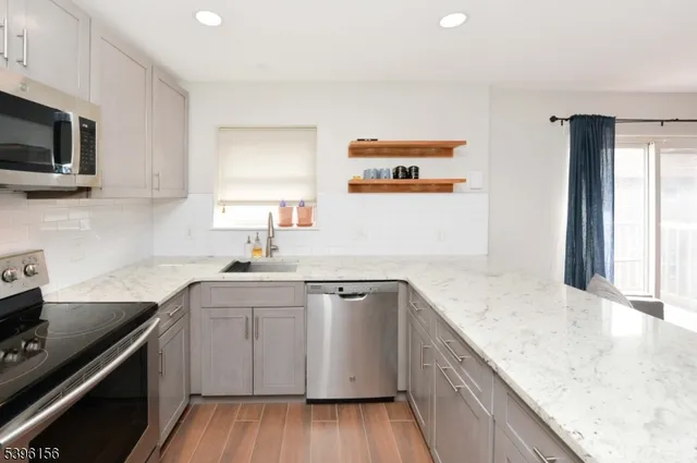 a kitchen with a sink a stove and cabinets