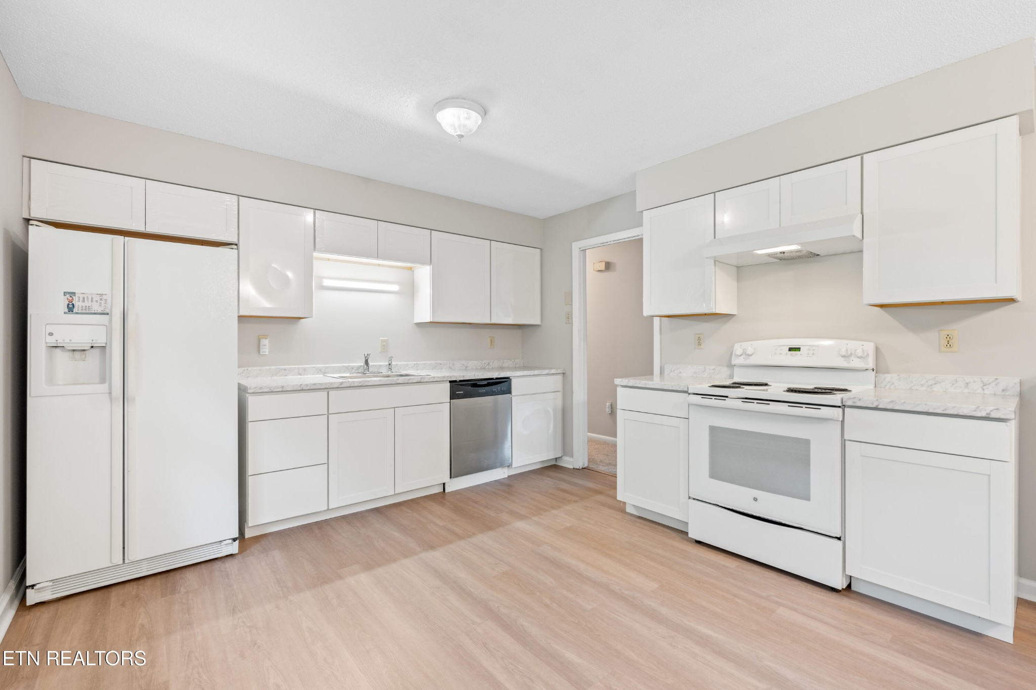 325 Blue Ridge Lane Seymour, TN 37865 - Photo 20 of 27 a kitchen with granite countertop white cabinets and white appliances