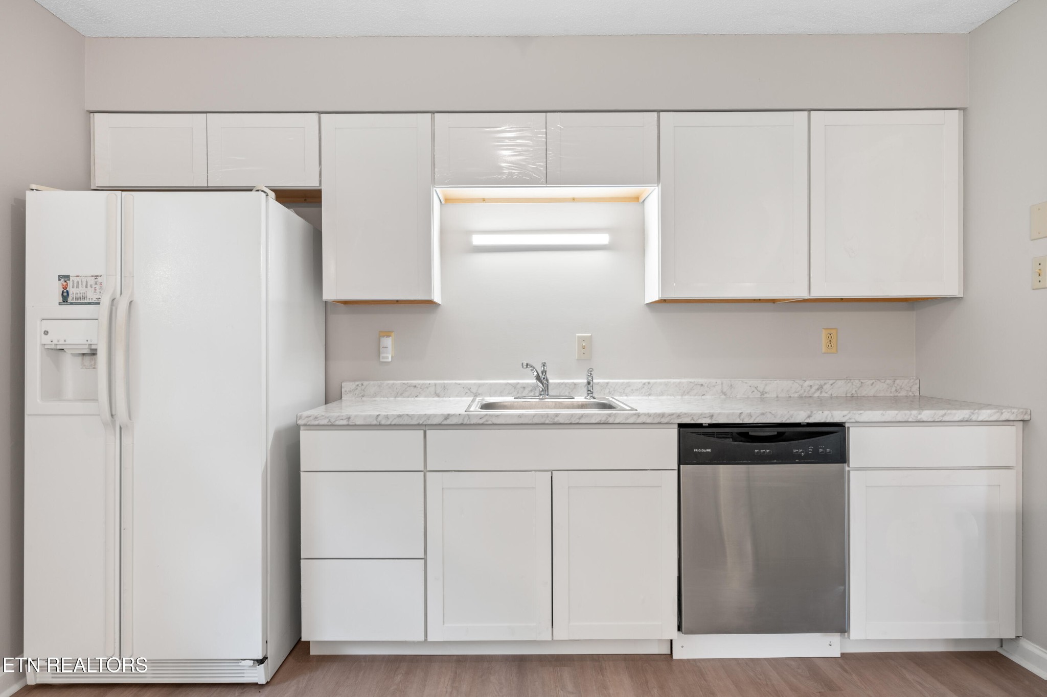 325 Blue Ridge Lane Seymour, TN 37865 - Photo 22 of 27 a kitchen with white cabinets and white appliances
