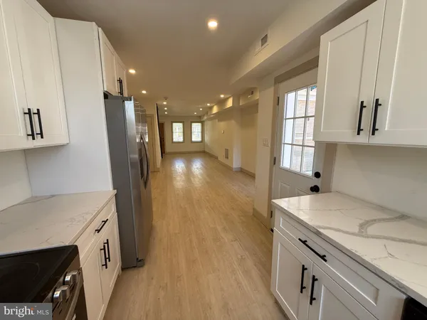 a view of a kitchen cabinets and a wooden floor