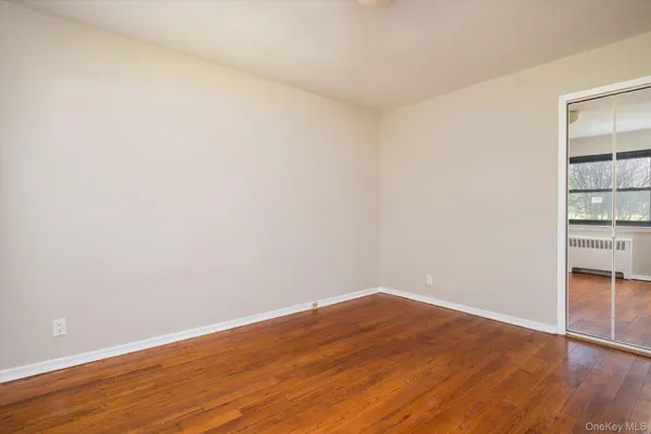 a view of a room with wooden floor