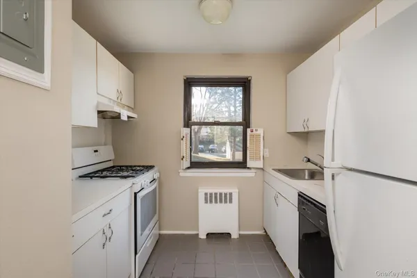 a kitchen with a stove a sink and a microwave